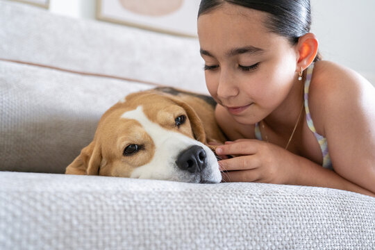 Girl Spends Time With Her Dog at Home During the Afternoon Hours