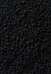 Fototapeta premium activated carbon granules close-up on black surface