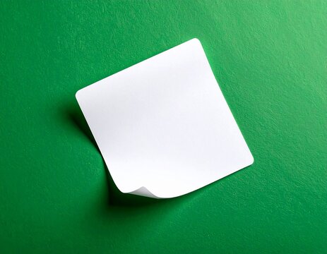 Blank White Paper with Curled Corner on Green Background
