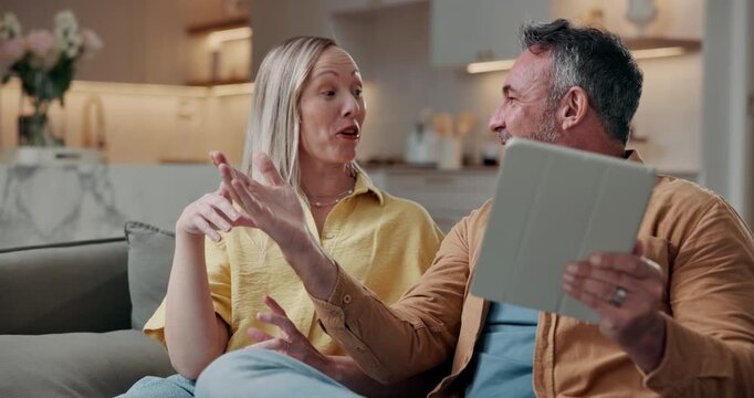 Couple, talk and planning in house with tablet, research interior design and online shopping for home. Married, mature man and woman in living room with tech, ecommerce website and point for decor.