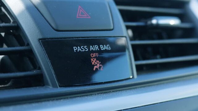 Macro detail of passenger airbag off indicator on car dashboard