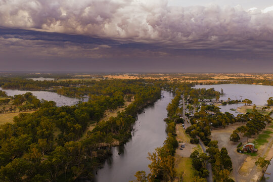 Dramatic storm clouds and rain rolling in over an inland river