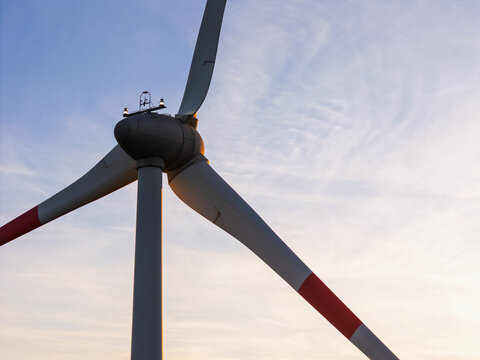 Aerial view of a wind turbine blade and hub against a clear sky in Slovenia.