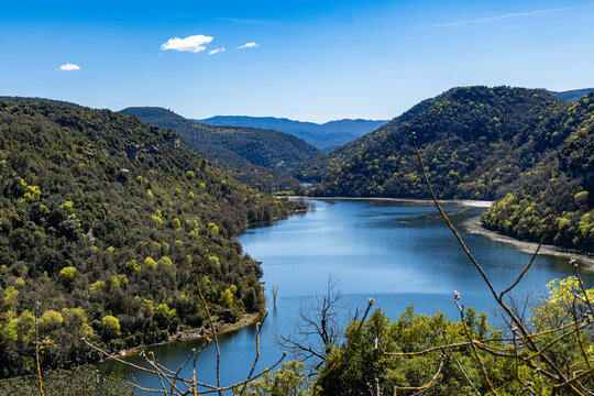Sau reservoir water flowing through forested valley, sant pere de casserres, Vic, Spain