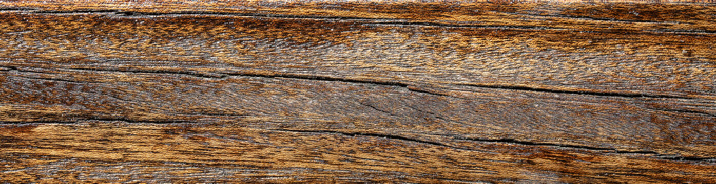 Old weathered brown wooden board surface with cracks texture background for rustic design	
