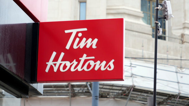 Manchester, England, UK - 18 June 2026: Tim Hortons sign, fast food restaurant logo close up, Canadian coffee shop exterior banner on building facade