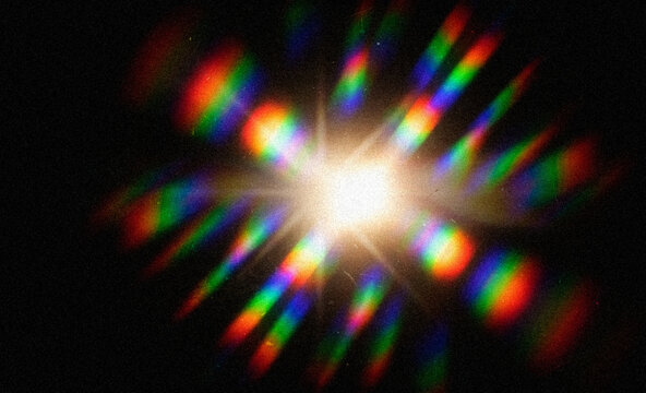 Abstract optical lens flare with rainbow prism light leaks on black background