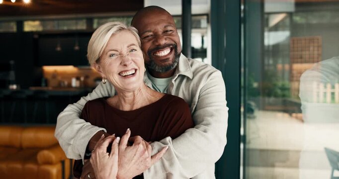 Happy, hug and face of couple in home with bonding, safety and connection in marriage together. Laugh, interracial people and portrait of mature man embracing woman for trust, commitment or loyalty.
