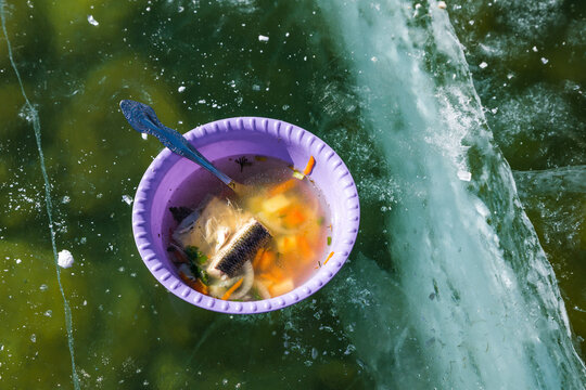 Ukha fish soup serving on Lake Baikal ice.