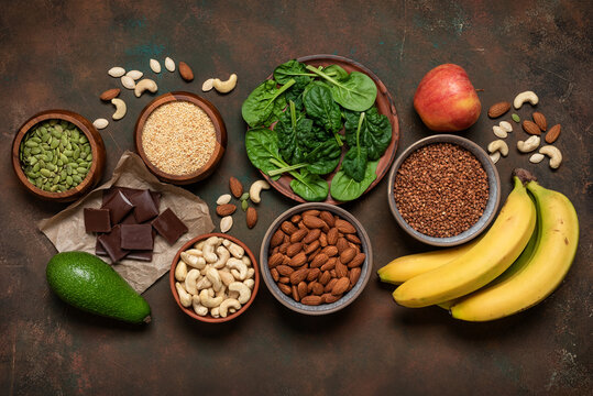 Magnesium rich food on dark grunge background, top view, flat lay, copy space. Various foods containing Mg