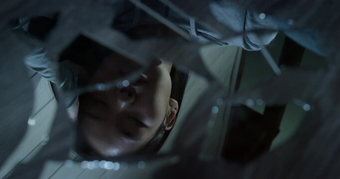 Woman look reflection shattered mirror. Broken glass shard. Psychological concept identity crisis, trauma, mental health struggle, depression despair. Upset girl feel ugly, pain. Self-doubt insecurity