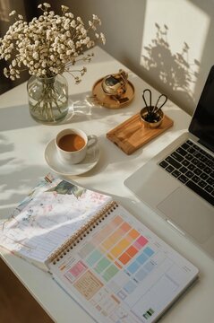 Workspace Setup With a Cup of Tea, Flowers, and a Laptop in the Afternoon