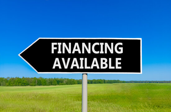 Financing available symbol. Concept words Financing available on beautiful black road sign. Beautiful blue sky green grass field background. Business financing available concept. Copy space.