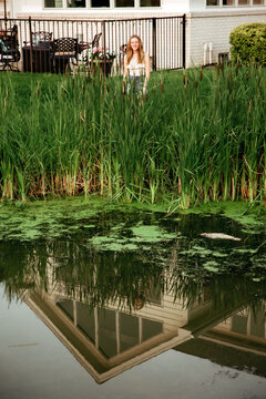 Girl standing by a marsh 