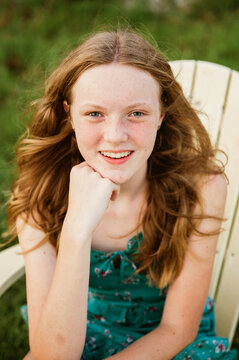 Portrait of a girl sitting in a chair. 