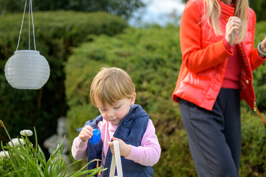 Toddler Finding Easter Egg Outdoors