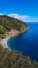 Obraz premium Top view of picturesque Spiaggia di Colle Palombaia beach on Elba Island in Tuscany, Italy.