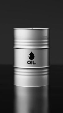 Silver metal oil barrel falling into a pond of crude oil with a dramatic liquid splash. Vertical video.