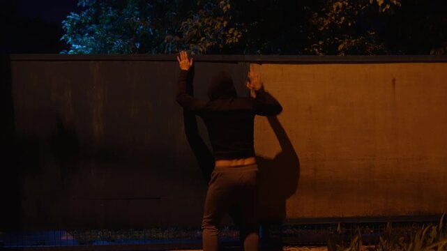 Thief climbing over fence of private property and running away fast