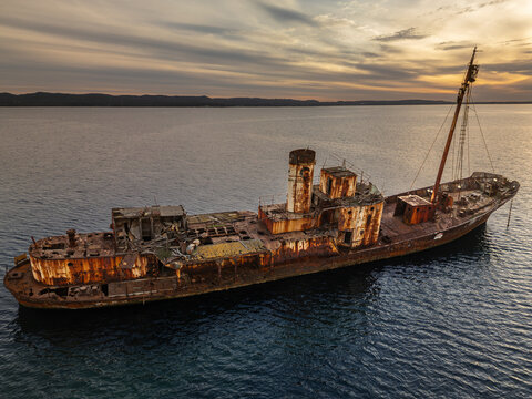 Aerial view of the rusted Cheynes II Whale Chaser shipwreck resting in the calm waters off the coast of Vancouver Peninsula, Western Australia, Australia.