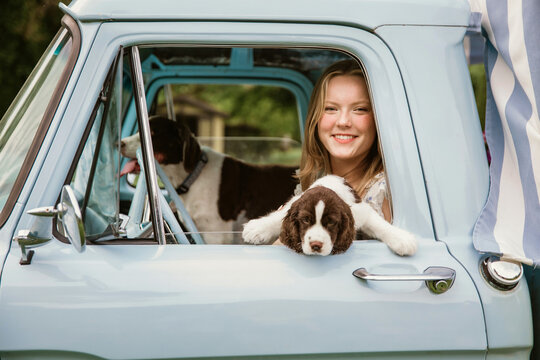 Teen girl in her truck with dogs