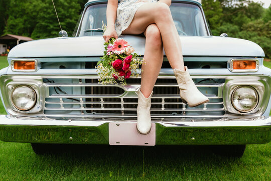 woman's legs on retro truck