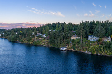 Fototapeta premium Waterfront Homes Along Forested Coastline at Swartz Bay, Vancouver Island, British Columbia, Canada