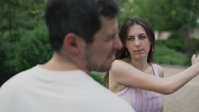 Angry young woman slapping her boyfriend in face during a heated argument