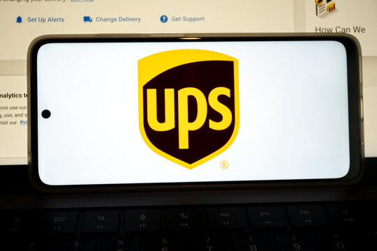 Smartphone displaying ups logo on keyboard