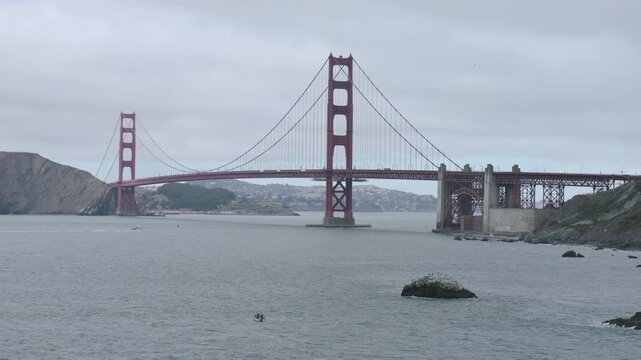 Golden Gate Bridge Wide View From Rocky Shoreline On Overcast Day - Wide Drone Shot
