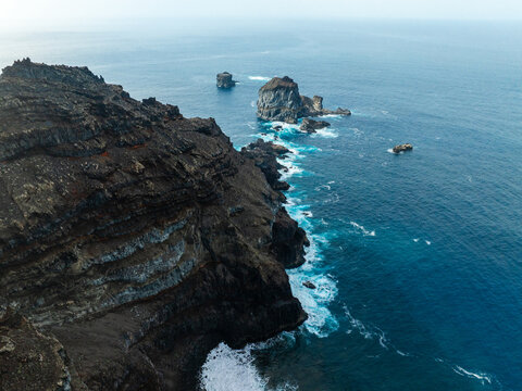 Aerial view of the volcanic cliffs and the Roques de Salmor rock formations rising from the Atlantic Ocean near Santa Cruz de Tenerife, Canarias, Spain.