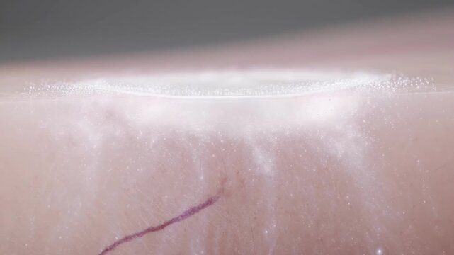 Luxury skincare moisturizer absorption into translucent skin with radiant microscopic hydration particles illuminating deep layers in a continuous cinematic shot