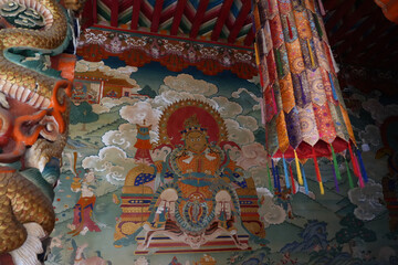 Tibetan Buddhist monastery interior with sacred mural and dragon carving © TrieuHao