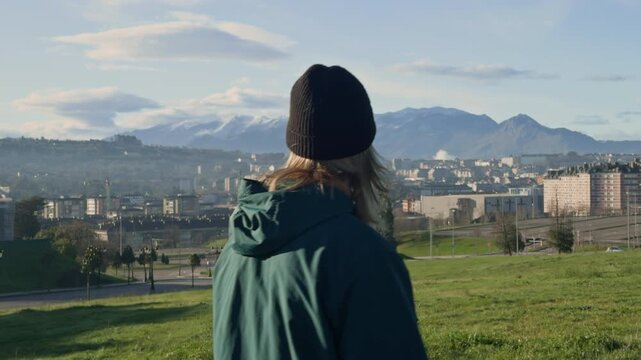 Following traveler with panoramic views over Oviedo and mountains.

Travel lifestyle footage capturing a peaceful walk above the city with breathtaking snowy peaks in the distance.