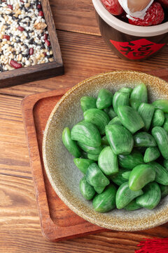 Green Pickled Laba Garlic with Festive Ingredients on Wooden Table