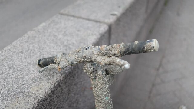 Detailed close up of unused shared electric scooter covered with surface deposits reflecting urban neglect and outdoor exposure