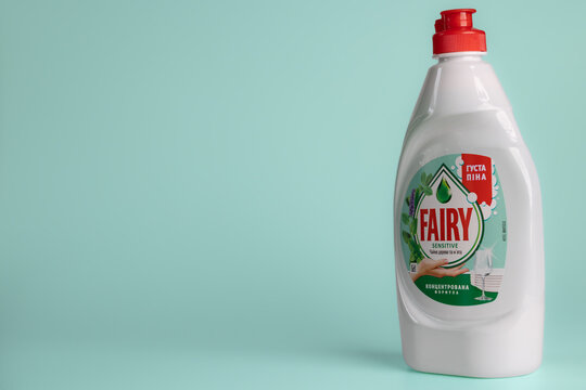 Fairy Sensitive Tea Tree and Mint dishwashing liquid white plastic bottle on turquoise background