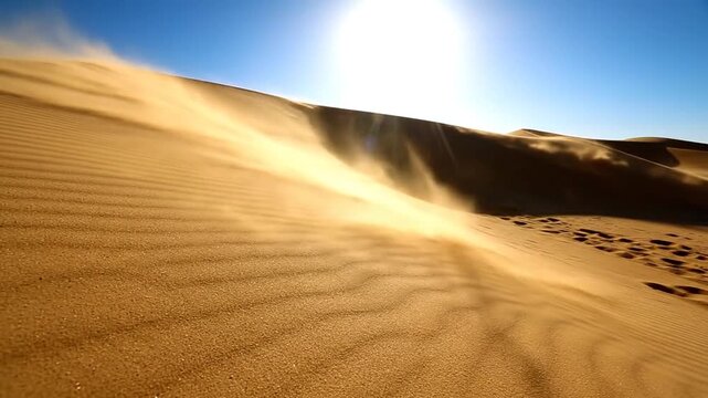 A dynamic desert landscape with golden sand dunes under a bright, sunny blue sky, where wind is actively blowing sand across the surface creating a sense of movement and arid environment