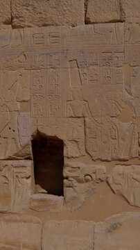 Close-up of detailed hieroglyphic rows with cartouches carved in stone lintel at Seti I temple Luxor Egypt.