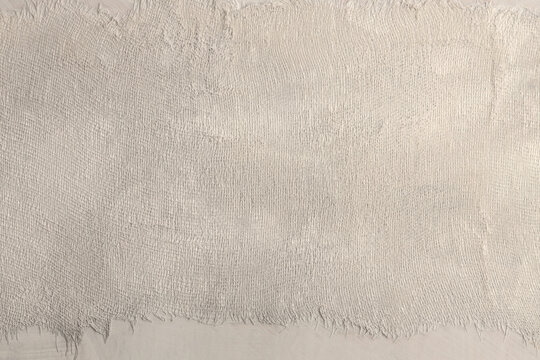 Torn, ripped blot crack crumble paper, fabric rustic canvas pieces collage. Gray, beige white copy space grunge dirty relief texture poster background.