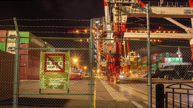 Night view time lapse of illuminated  Container Terminal behind a keep out fence in Tokyo