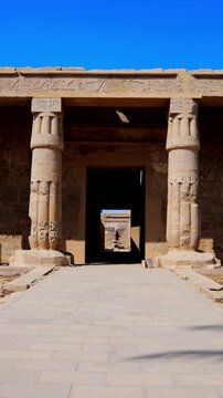 Seti I mortuary temple entrance with palm tree alley and ancient stone ruins in