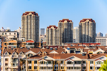 Modern Apartment Towers Above Residential Rooftops © KieuLan