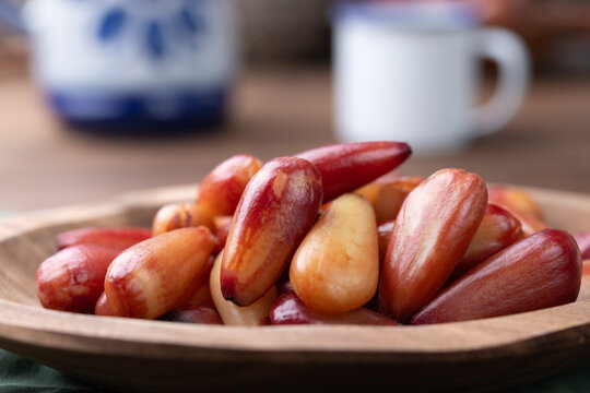 Cooked pinions or araucaria seeds on a bowl over wooden table