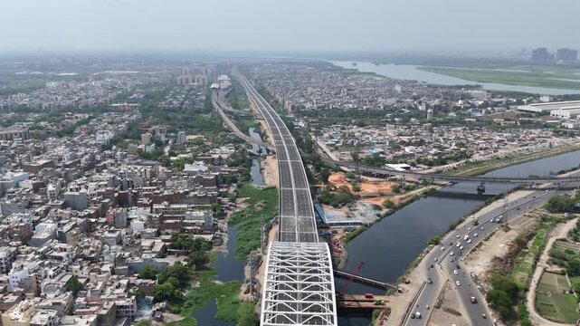 Aerial drone view of Delhi Mumbai Expressway corridor and Delhi Metro near Kalindi Kunj, Delhi India