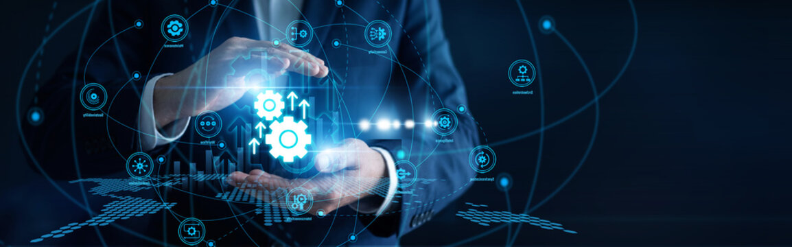 Systems operator hands hold control panels launching robotic industrial Automation workflows. Advanced mechanical systems eliminate repetitive manual errors to boost overall factory output.