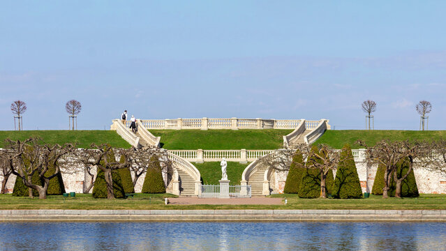 Panoramic view of Marlinsky Ramp staircase and formal gardens reflected in Marlinsky Pond at Peterhof Palace, Saint Petersburg, Russia