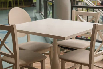 Fotobehang Horeca Modern Cafe Table with White Chairs Near Window, Empty Restaurant Interior with Copy Space  © Валентина Руденька
