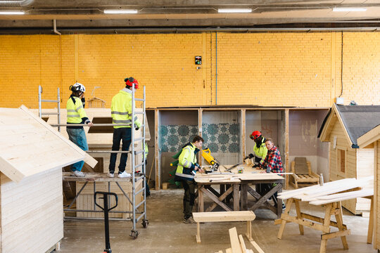 Vocational students doing carpentry tasks in workshop at upper secondary school