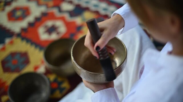 serene meditation session with tibetan singing bowls being played with mallets